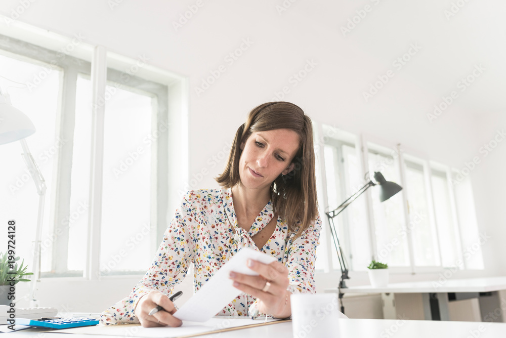 Female accountant working with receipts Female accountant working with receipts