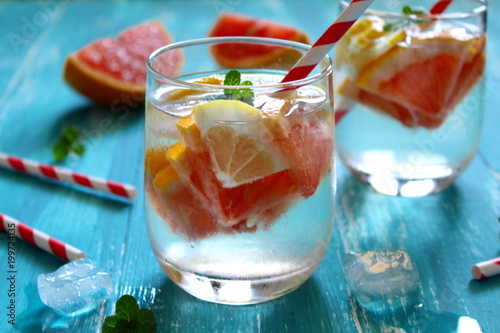 Summer drinks with grapefruit, lemon and ice. Top view. photo