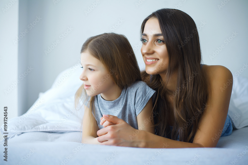 Happy mother and daughter lying in bed Happy mother and daughter lying in bed