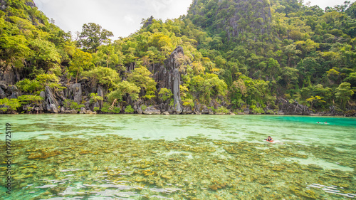 Twin Lagoon in Coron, Palawan, Philippines. Mountain and Sea. Lonely Boat. Tour A. photo