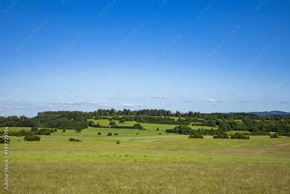 typical rural landscape with meadows and fields in the Jura region, departement Bourgogne