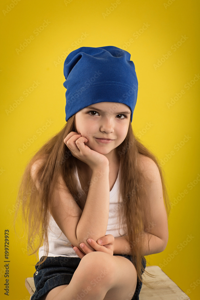 Beautiful caucasian girl posing in studio on a Yellow background