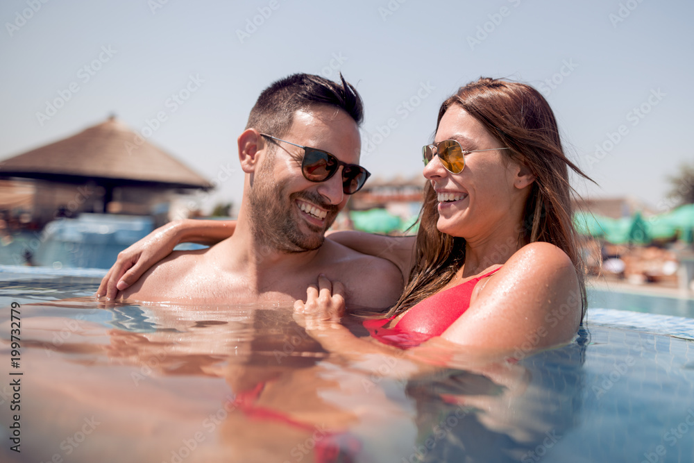 Fototapeta premium Couple having fun in a swimming pool