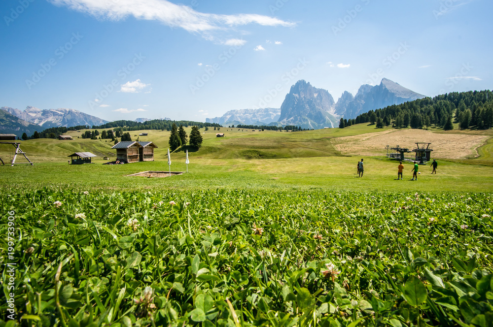 Guys play soccer on the pastures of the Alpe di Siusi, Ortisei, Dolomites, Italy Guys play soccer on the pastures of the Alpe di Siusi, Ortisei, Dolomites, Italy