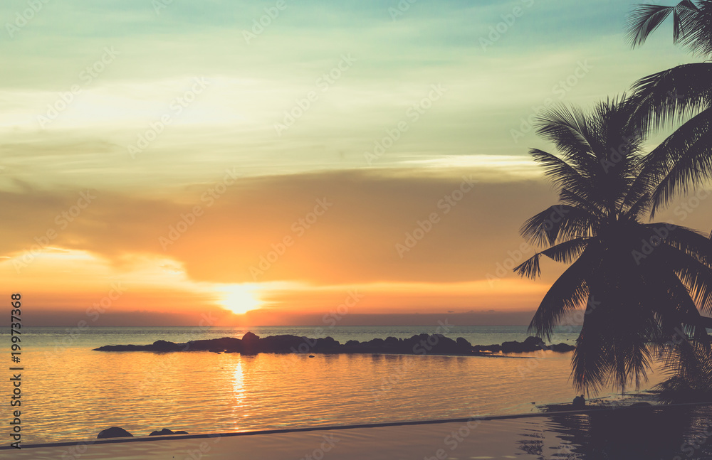 Vintage, peaceful sunset by infinity pool in the island of Koh Phangan, Thailand. Summer vacation, travel destination concept. Tropical twilight, orange dusk, relax at resort
