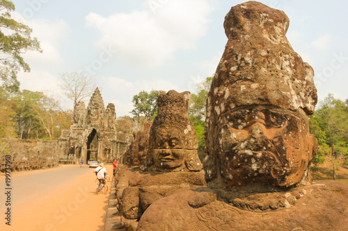 Faces statues on Angkor Wat temples bridge in Siem Reap, Cambodia. Ancient civilization landmark. Tourist attraction concept. Unesco World Heritage Site
