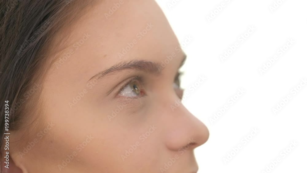 Portrait of young beautiful woman dressed pink sitting in beauty salon and stylist applies tone on nose Portrait of young beautiful woman dressed pink sitting in beauty salon and stylist applies tone on nose