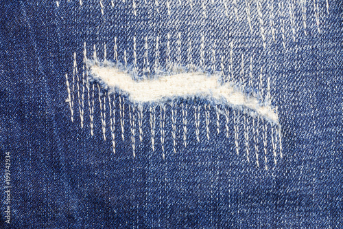 Foto Jeans torn denim texture background.