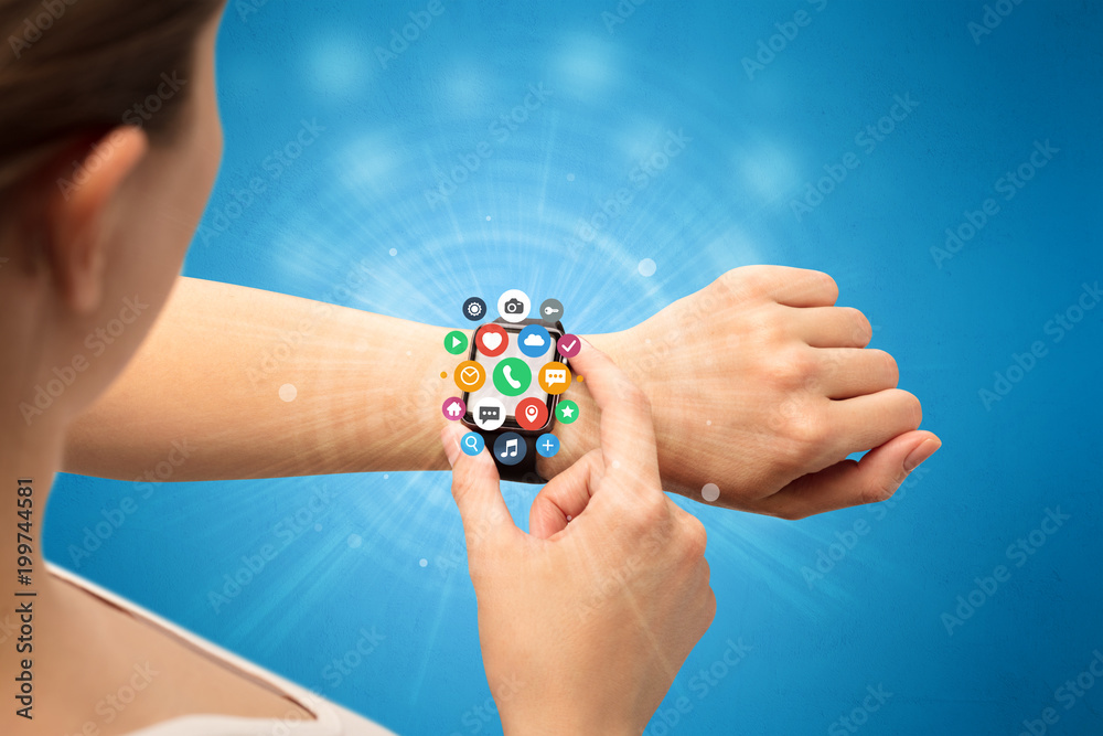 Hand with smartwatch and application symbols nearby. Hand with smartwatch and application symbols nearby.