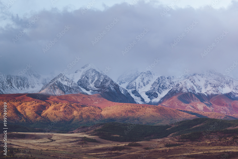 Beautiful view of the snowy mountain peaks. Colorful mountain valley with rocks.