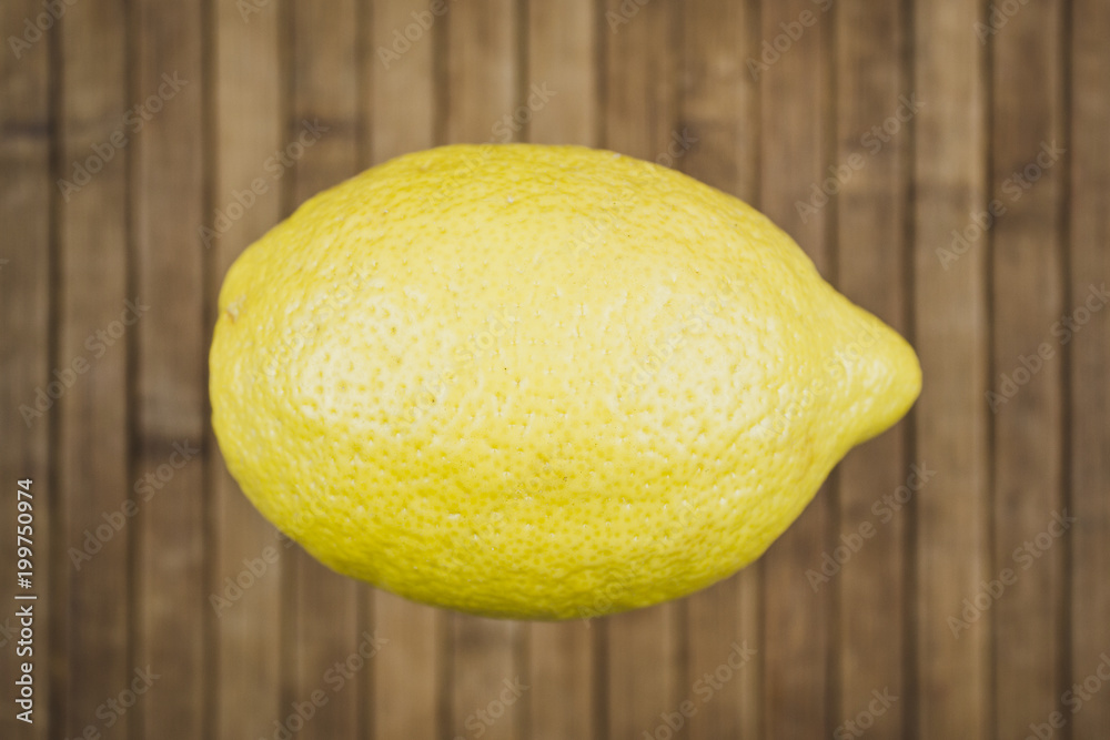 Yellow lemon on wooden table