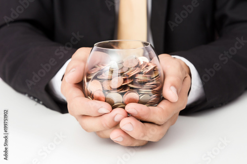 Businessman hand putting the coins on the glass, concept of saving money for finance accounting