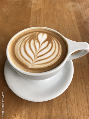 chocolate mocha or caramel latte with beautiful design in a cup of coffee on a table in fancy cafe in Portland Oregon USA