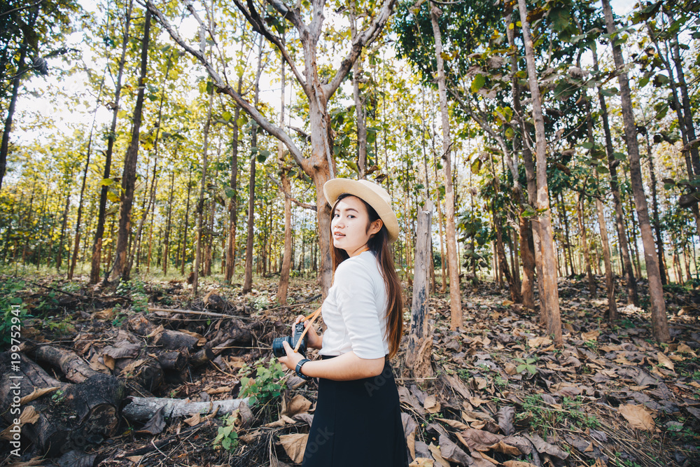 Freedom hipster girl travel in forest with mirrorless camera Freedom hipster girl travel in forest with mirrorless camera