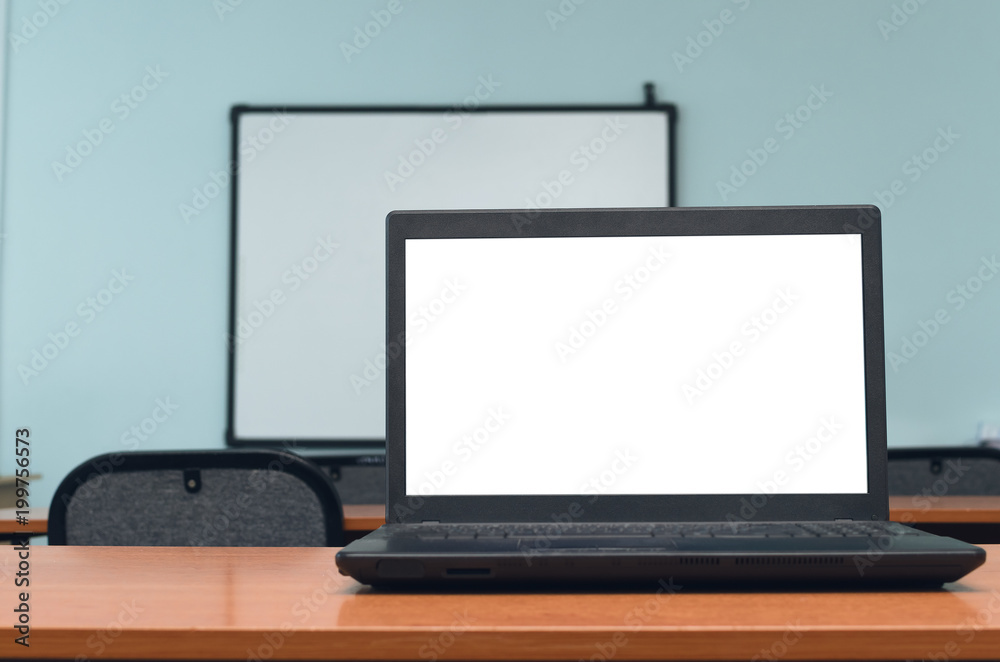 Laptop computer with blank white screen on the school desk table in classroom. Education concept background. Laptop computer with blank white screen on the school desk table in classroom. Education concept background.
