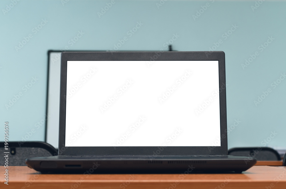 Laptop computer with blank white screen on the school desk table in classroom. Education concept background. Laptop computer with blank white screen on the school desk table in classroom. Education concept background.