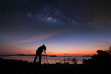 Photographer doing photography sunrise with milky way galaxy.