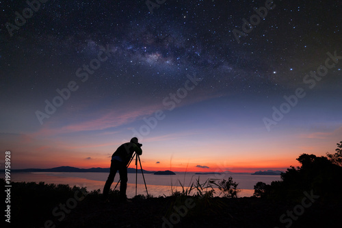 Photographer doing photography sunrise with milky way galaxy.