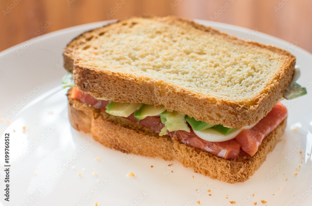 healthy Breakfast: toast with avocado, salmon and egg on wholemeal bread. Mediterranean diet, healthy food.