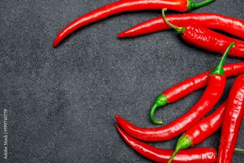 red chili pepper on dark concrete background