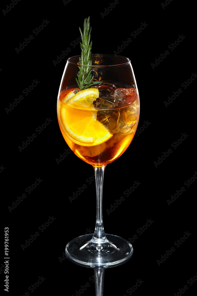 Cold Apple and orange cocktail with a sparkling wine with ice in wine glass isolated on black Cold Apple and orange cocktail with a sparkling wine with ice in wine glass isolated on black