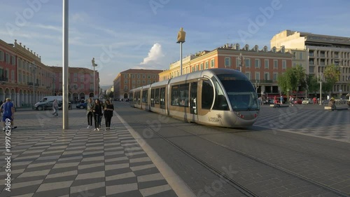 A tram rolling in a city square photo