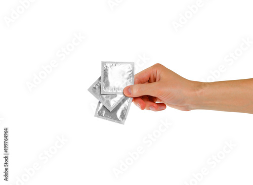 Man's hand holding three condoms. Close up. Isolated on white background