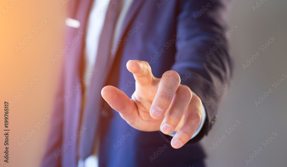 Naklejka premium Businessman touching with his finger an interface on a color background