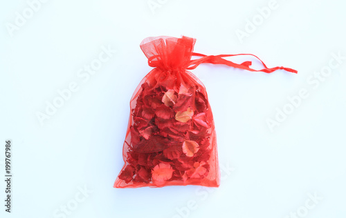 Dried flower in red bag on white background.