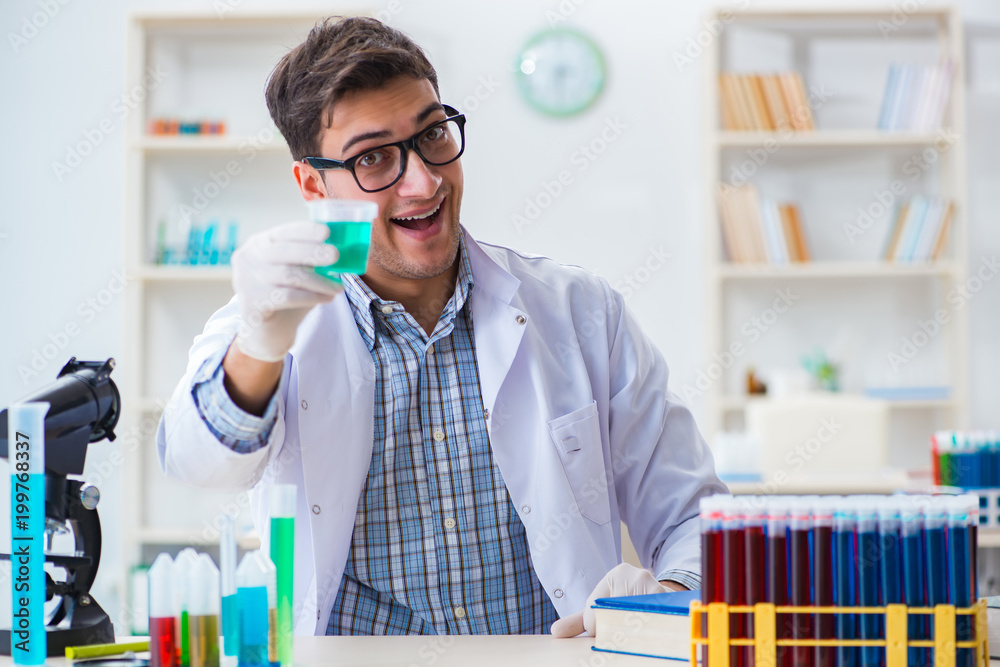 Young chemist student working in lab on chemicals Young chemist student working in lab on chemicals