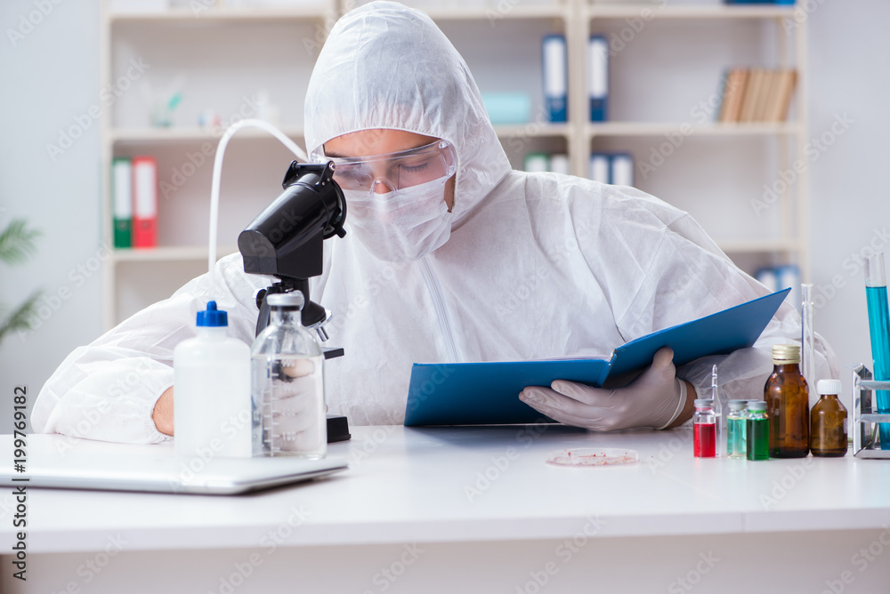 Young chemist student working in lab on chemicals Young chemist student working in lab on chemicals