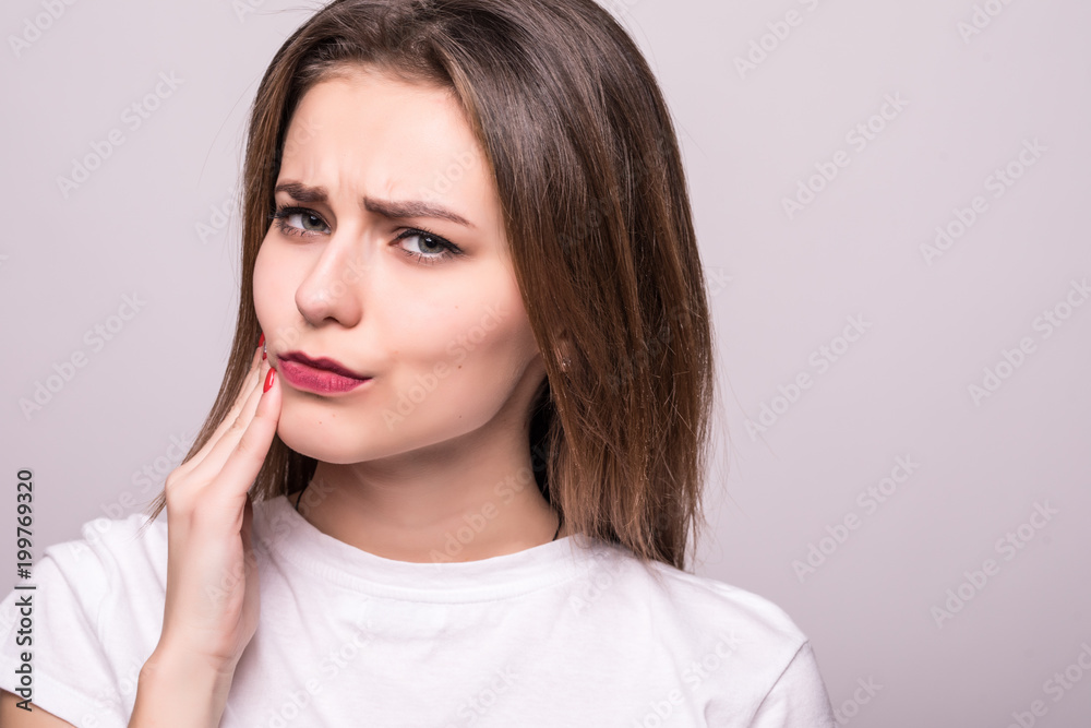 woman suffering from toothache, tooth decay or sensitivity isolated on gray woman suffering from toothache, tooth decay or sensitivity isolated on gray