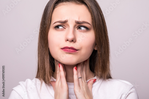 Young woman with sore throat isolated on white background