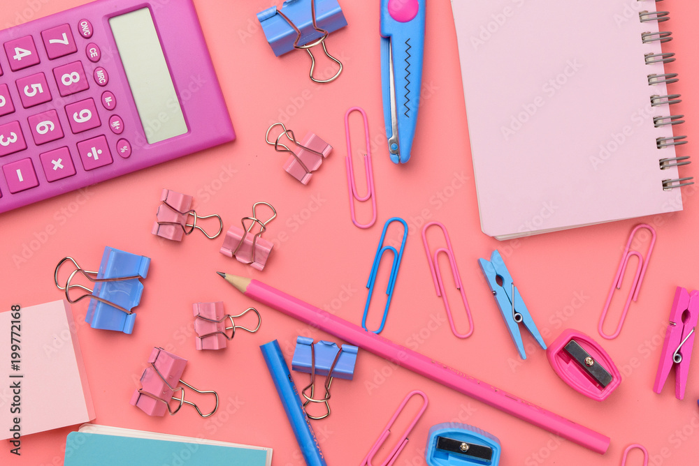 Stationary concept, Flat Lay top view Photo of Scissors, pencils, paper clips,calculator,sticky note,stapler and notepad in pink and blue tone on pink background with copy space Stationary concept, Flat Lay top view Photo of Scissors, pencils, paper clips,calculator,sticky note,stapler and notepad in pink and blue tone on pink background with copy space