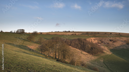 Stunning vibrant sunrise landscape image over English countryside landscape with lovely light hitting the hills