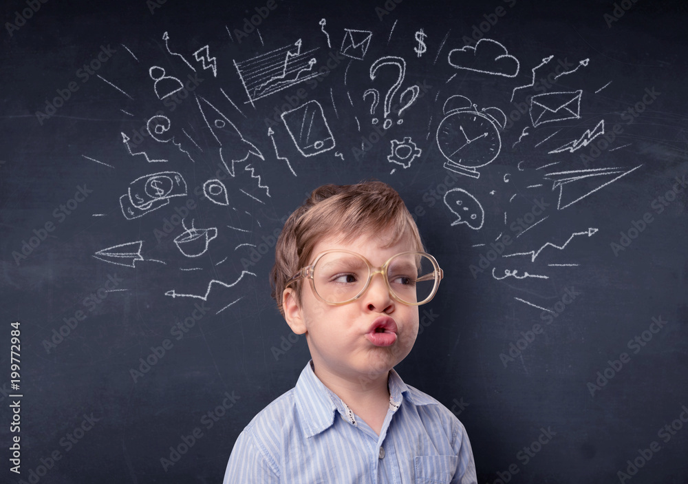 Smart little kid in front of a drawn up blackboard ruminate