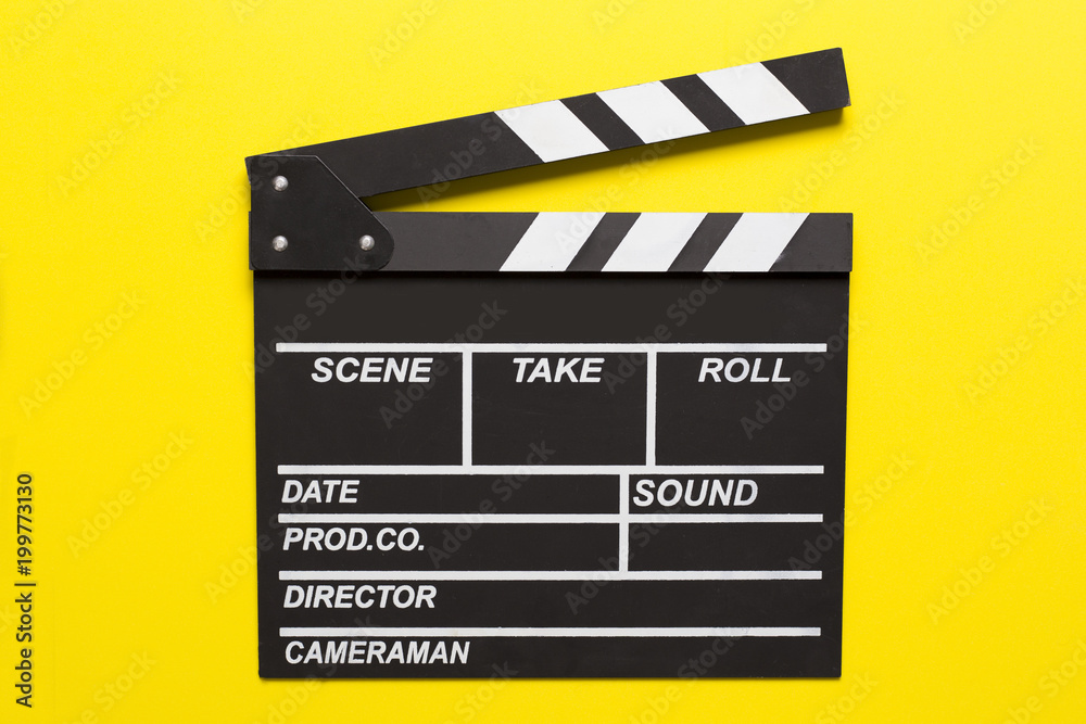 movie clapper on yellow background; film, cinema and vedio photography concept