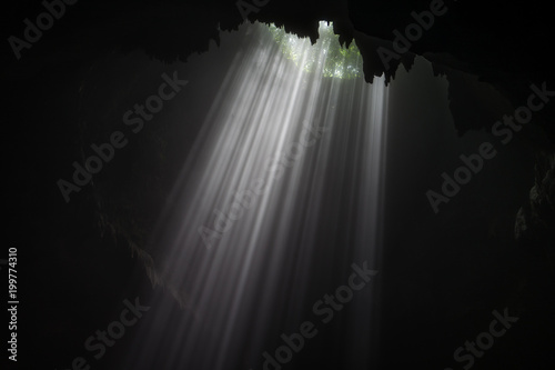 Illuminated cave at Goa Jomblang Tour near Yogyakarta, Indonesia photo
