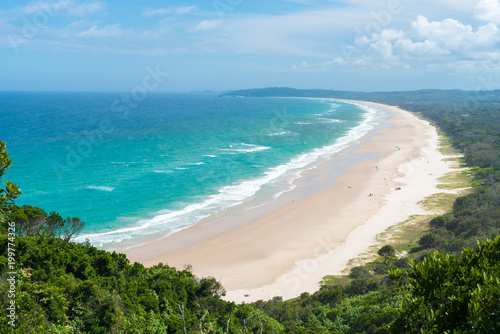 View over Tallow Beach with turquoise waters in Arakwai National Park at Byron Bay, NSW, Australia.