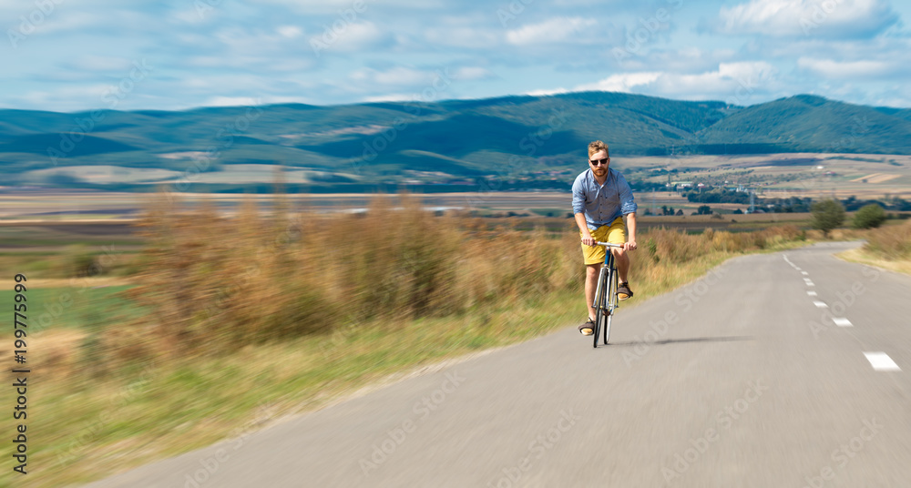 Obraz premium Natural view with cyclist going somewhere with stylish bike