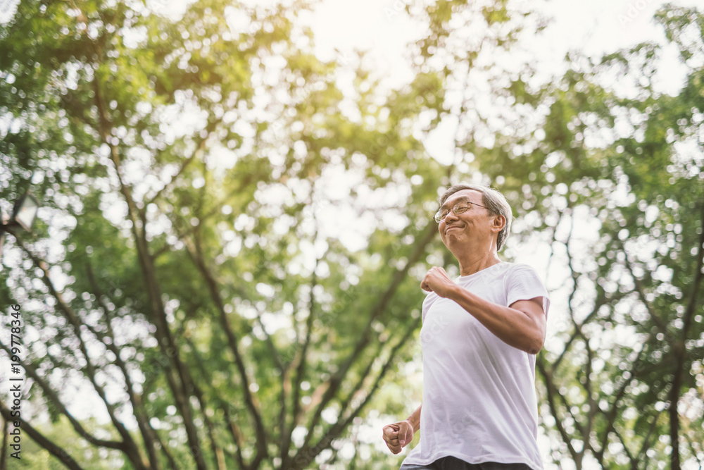 Asian senior mature man running Jogging In Park Asian senior mature man running Jogging In Park