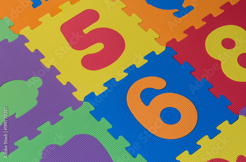 Colourful alphabet puzzle pieces and letter tiles background