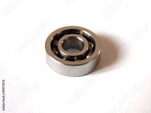 Ball bearing close-up. Photo of a ball-bearing on a white background. Metal ball-bearing friction.