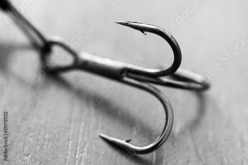 Quadro su tela Fishing hook on wooden background, macro