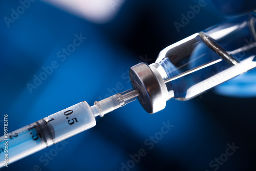 Medical hands holds syringe and vaccine