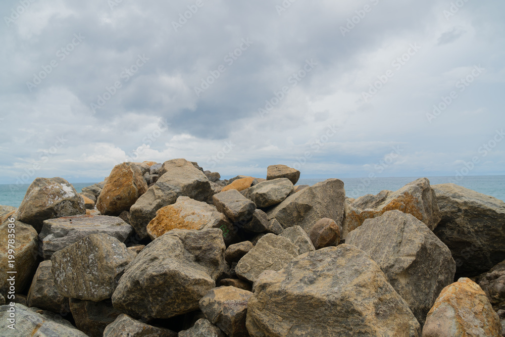 A ridge of rocks in the ocean.