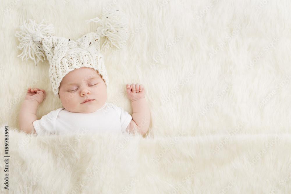 Sleeping Newborn Baby in Woolen Hat, New Born Kid Sleep in Bed Covered with Fur Blanket Sleeping Newborn Baby in Woolen Hat, New Born Kid Sleep in Bed Covered with Fur Blanket