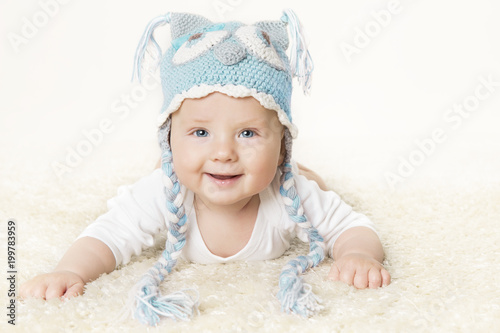 Happy Baby in Blue Knitted Hat, Kid Boy Raising Head, Smiling Infant Child Portrait, six months old