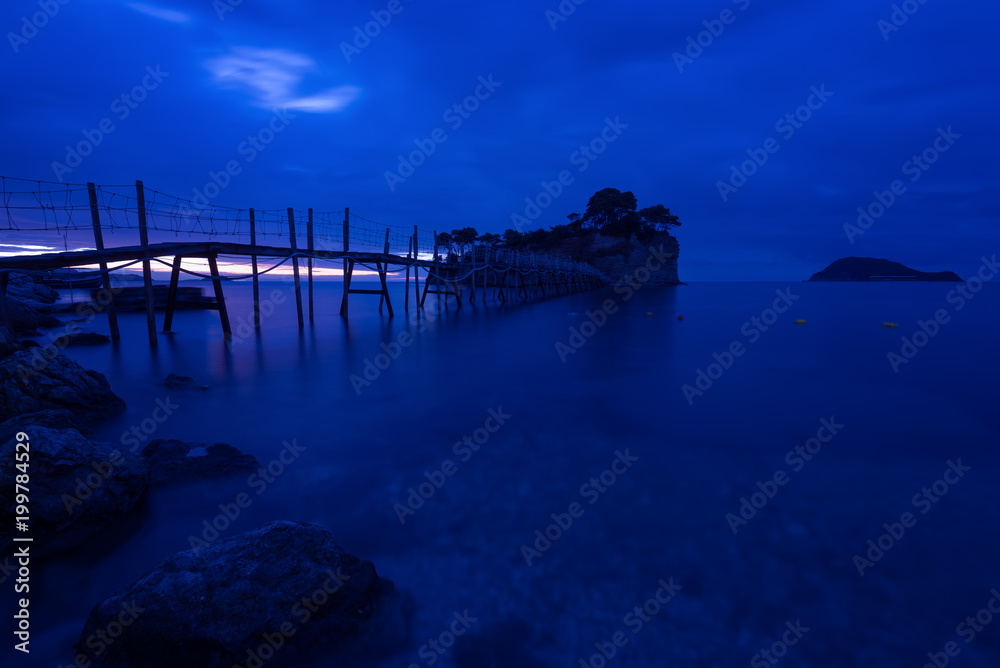 View from Agios Sostis and Cameo island with wooden bridge shot before sunrise . Zakynthos Greece.