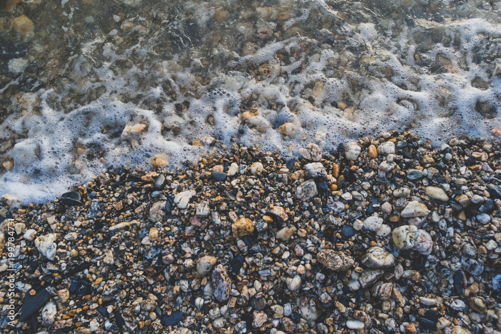 Pebble beach with sea water close up Pebble beach with sea water close up